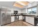 Modern kitchen with stainless steel appliances, white cabinets, and generous counter space at 1607 E Gable Ave, Mesa, AZ 85204