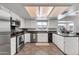 Spacious kitchen features white cabinets, stainless steel appliances, and lots of counter space at 1607 E Gable Ave, Mesa, AZ 85204