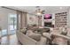 Comfortable living room featuring built-in shelves, fireplace, and backyard access at 1607 E Gable Ave, Mesa, AZ 85204