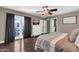 Bright main bedroom features a ceiling fan, hardwood floors, and a sliding glass door at 1607 E Gable Ave, Mesa, AZ 85204