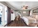 The expansive main bedroom has sliding doors to the outside and dark wood floors at 1607 E Gable Ave, Mesa, AZ 85204