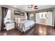 This spacious main bedroom boasts a ceiling fan and ensuite bathroom with barn door at 1607 E Gable Ave, Mesa, AZ 85204