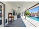 Charming covered patio with a dining area, offering serene views of the pool and backyard at 1607 E Gable Ave, Mesa, AZ 85204