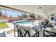 Spacious covered patio with outdoor seating overlooking a beautiful pool and landscaped backyard at 1607 E Gable Ave, Mesa, AZ 85204