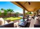 Inviting backyard with a covered patio, comfortable seating, mini-golf, and a refreshing swimming pool at 17613 W Gelding Dr, Surprise, AZ 85388