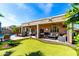 A lush putting green offers a unique leisure space, seamlessly integrated with an outdoor living area at 17613 W Gelding Dr, Surprise, AZ 85388