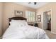 Inviting bedroom with a plush bed, wood headboard, shuttered window, and decorative touches at 17613 W Gelding Dr, Surprise, AZ 85388