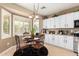 Bright and inviting breakfast nook features shuttered windows and plenty of natural light at 17613 W Gelding Dr, Surprise, AZ 85388