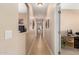Hallway with a decorative tile floor, leads to the bedrooms and office at 17613 W Gelding Dr, Surprise, AZ 85388