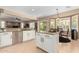 Bright kitchen with granite counters, white cabinets, a center island and modern stainless steel appliances at 17613 W Gelding Dr, Surprise, AZ 85388