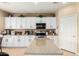 Kitchen with white cabinets, granite counters, stainless steel appliances and a center island at 17613 W Gelding Dr, Surprise, AZ 85388