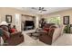 Inviting living room features plush seating, a ceiling fan, and a recessed TV area at 17613 W Gelding Dr, Surprise, AZ 85388