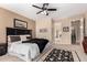 Cozy carpeted main bedroom with dark furniture and decor and neutral paint at 17613 W Gelding Dr, Surprise, AZ 85388