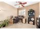 Dedicated office space with ceiling fan, large desk, and storage shelves at 17613 W Gelding Dr, Surprise, AZ 85388