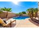 Sparkling blue swimming pool surrounded by desert landscaping and lounge chairs, perfect for relaxation at 17613 W Gelding Dr, Surprise, AZ 85388