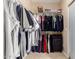 Walk-in closet providing generous storage space for clothes, shoes, and accessories at 17613 W Gelding Dr, Surprise, AZ 85388