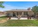 Backyard with patio, grill, desert landscaping, and ample space, ideal for outdoor living and entertainment at 19046 N Signal Butte Cir, Sun City, AZ 85373