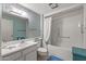 Well-lit bathroom with a shower and tub, vanity, and decorative wallpaper for a serene feel at 19046 N Signal Butte Cir, Sun City, AZ 85373