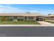 Single story home with a well-maintained lawn and covered parking, plus a charming front porch at 19046 N Signal Butte Cir, Sun City, AZ 85373
