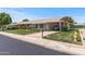 Single-story home featuring a covered carport, well-kept lawn, and mature landscaping for cozy curb appeal at 19046 N Signal Butte Cir, Sun City, AZ 85373