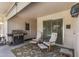 Covered patio with grill, comfortable seating, and outdoor access at 19046 N Signal Butte Cir, Sun City, AZ 85373