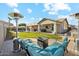Inviting backyard featuring a cozy seating area with a fire pit and well-manicured lawn at 19305 E Oriole Way, Queen Creek, AZ 85142