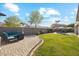 Lush backyard with a manicured lawn and a cozy seating area, is great for outdoor activities at 19305 E Oriole Way, Queen Creek, AZ 85142