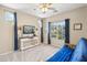 Well-lit bedroom with a ceiling fan, blue curtains, and ample natural light, creating a comfortable and airy space at 19305 E Oriole Way, Queen Creek, AZ 85142