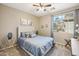 Cozy bedroom with a modern bed, accent wall decorations, and a bright window, creating a welcoming retreat at 19305 E Oriole Way, Queen Creek, AZ 85142