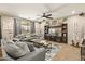 Inviting living room with a cozy sectional sofa, custom built-in entertainment center, and neutral decor at 19305 E Oriole Way, Queen Creek, AZ 85142