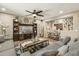Cozy living room featuring a comfortable sectional, stylish decor, and an open view to the adjacent room at 19305 E Oriole Way, Queen Creek, AZ 85142