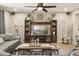 Comfortable living room with sectional sofa, ceiling fan, and entertainment center with decorative accents at 19305 E Oriole Way, Queen Creek, AZ 85142