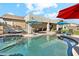 Sparkling pool with a tanning ledge is surrounded by ample seating, perfect for entertaining at 19305 E Oriole Way, Queen Creek, AZ 85142