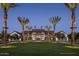 Stately clubhouse entrance with manicured lawn and palm trees, exuding luxury and community at 1948 W Rowel Rd, Phoenix, AZ 85085