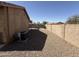Well-maintained backyard with gravel landscaping, citrus tree, and block wall, for added privacy at 2132 W Gold Dust Ave, San Tan Valley, AZ 85144