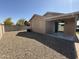 Spacious backyard with low maintenance landscaping, a covered patio, and block wall fencing at 2132 W Gold Dust Ave, San Tan Valley, AZ 85144