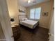 This cozy bedroom includes a metal bed frame, neutral walls, and wood-look flooring at 2132 W Gold Dust Ave, San Tan Valley, AZ 85144