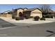 Inviting single-story home showcasing a manicured yard with lush landscaping, gravel, and healthy plants at 2132 W Gold Dust Ave, San Tan Valley, AZ 85144