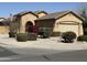 Attractive exterior showcasing an American flag, manicured gravel landscaping, and lush, thriving flowering bushes at 2132 W Gold Dust Ave, San Tan Valley, AZ 85144