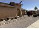 Desert-scape landscaped front yard with an arched entryway and charming American flag on display at 2132 W Gold Dust Ave, San Tan Valley, AZ 85144