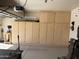 Spacious garage featuring built in cabinets for ample storage, and a visible garage door opener at 2132 W Gold Dust Ave, San Tan Valley, AZ 85144