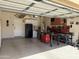 Bright, organized garage featuring custom storage cabinets, work benches and sealed concrete floors throughout at 2132 W Gold Dust Ave, San Tan Valley, AZ 85144
