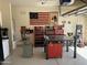 Garage with custom work benches, tool storage, decorative flags and decals on a sealed concrete floor at 2132 W Gold Dust Ave, San Tan Valley, AZ 85144