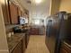 Modern kitchen with stainless steel appliances, wood cabinets, and granite countertops at 2132 W Gold Dust Ave, San Tan Valley, AZ 85144