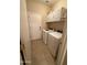 Bright laundry room with tile floors, a white washer, dryer, and overhead storage cabinets at 2132 W Gold Dust Ave, San Tan Valley, AZ 85144