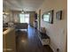 Spacious open concept living room area with wood floors, modern decor, and an American flag-themed bench at 2132 W Gold Dust Ave, San Tan Valley, AZ 85144