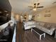 Spacious living room featuring a ceiling fan, wood floors, and comfortable sectional sofa at 2132 W Gold Dust Ave, San Tan Valley, AZ 85144