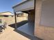 View of a covered patio with a retractable awning, next to a lush backyard at 2132 W Gold Dust Ave, San Tan Valley, AZ 85144