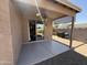 Covered patio with ceiling fan, with access to the yard with a grill and an American flag at 2132 W Gold Dust Ave, San Tan Valley, AZ 85144
