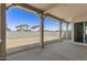 Covered back patio with views of a spacious backyard and the neighboring homes at 2149 W Rowel Rd, Phoenix, AZ 85085